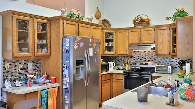 kitchen with sink, stainless steel appliances, and tasteful backsplash