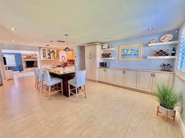 dining space with a textured ceiling, light hardwood / wood-style floors, and a healthy amount of sunlight