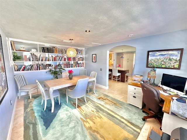 dining room with a textured ceiling