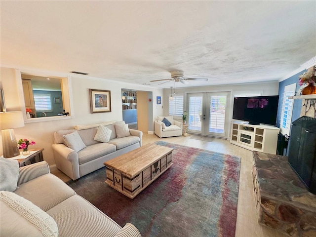 living room featuring french doors, dark hardwood / wood-style flooring, ceiling fan, and crown molding