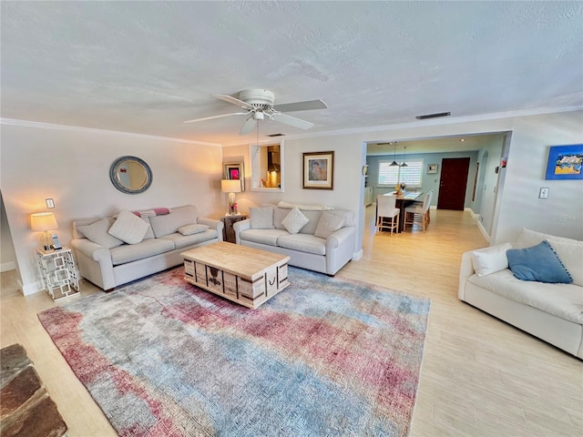 living room with ceiling fan, light hardwood / wood-style flooring, and crown molding