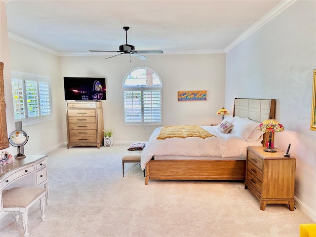 carpeted bedroom with ceiling fan and ornamental molding