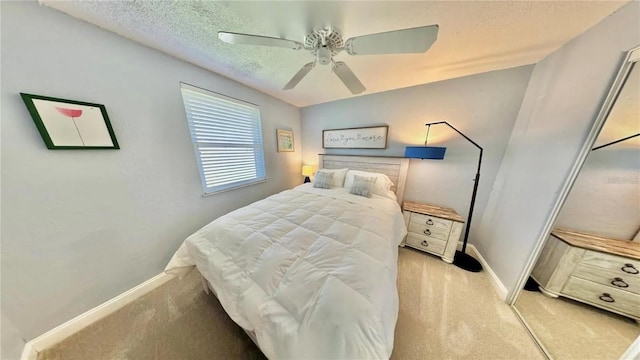 carpeted bedroom with ceiling fan and a textured ceiling