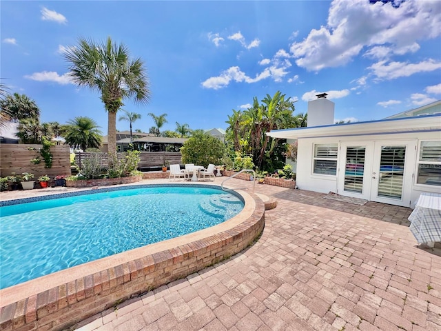 view of pool featuring a patio area and french doors