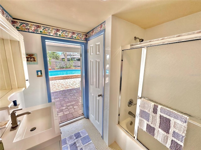 bathroom featuring vanity and enclosed tub / shower combo