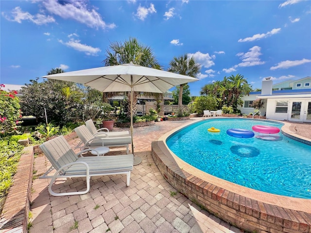 view of pool with a jacuzzi and a patio