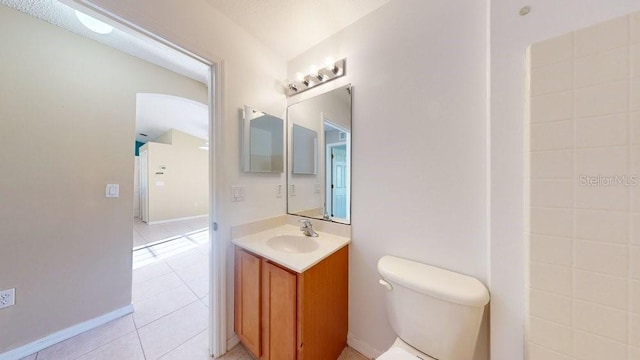 bathroom with tile patterned flooring, vanity, and toilet