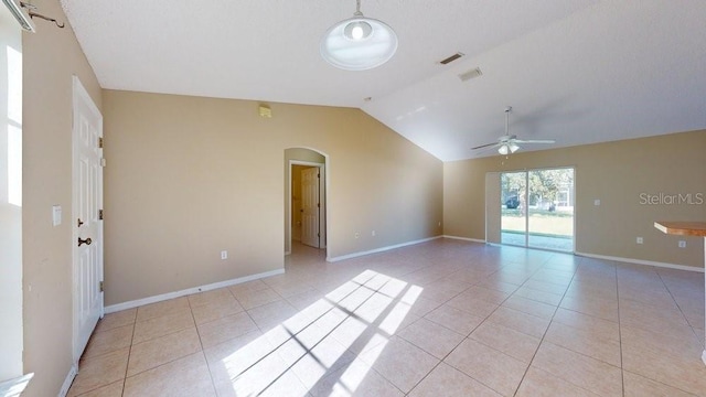 unfurnished room featuring ceiling fan, lofted ceiling, and light tile patterned floors