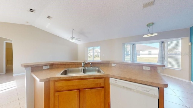 kitchen featuring white dishwasher, sink, vaulted ceiling, ceiling fan, and a textured ceiling