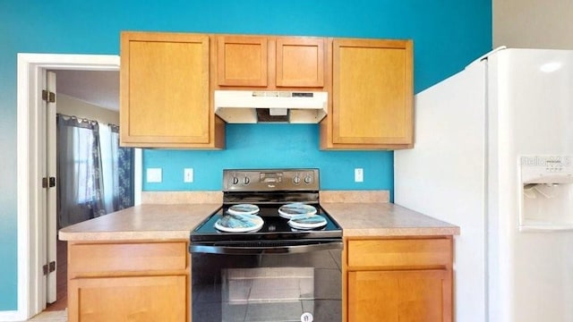 kitchen featuring black range with electric stovetop and white fridge with ice dispenser