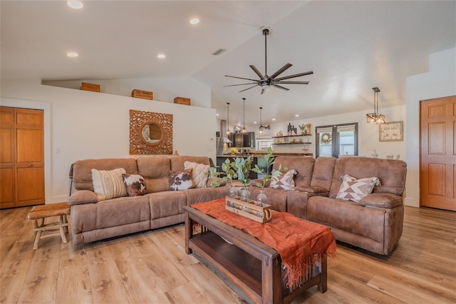 living room with light wood-type flooring, vaulted ceiling, and ceiling fan