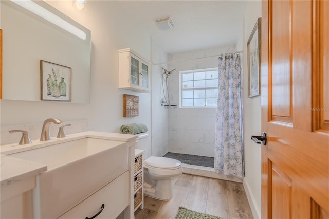 bathroom featuring toilet, a shower with curtain, vanity, and hardwood / wood-style floors