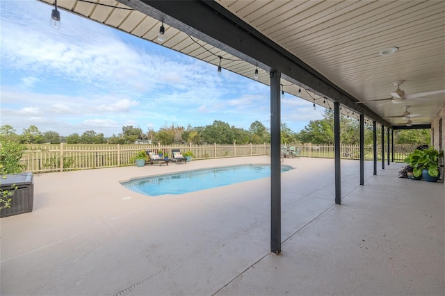 view of swimming pool featuring a patio and ceiling fan