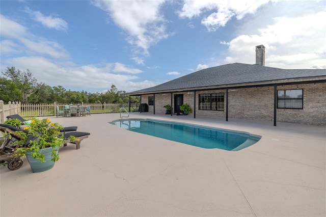 view of swimming pool with a patio