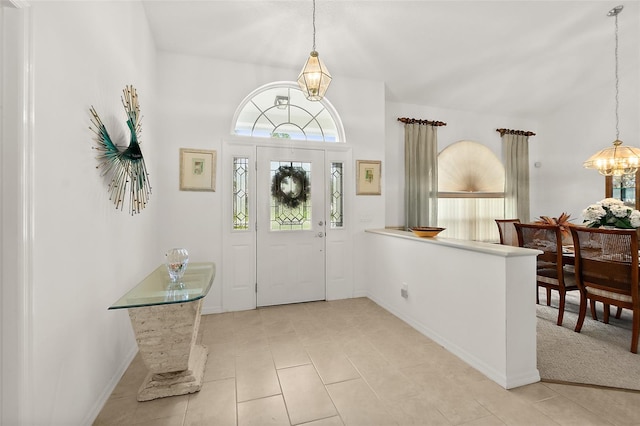 tiled foyer entrance with a notable chandelier