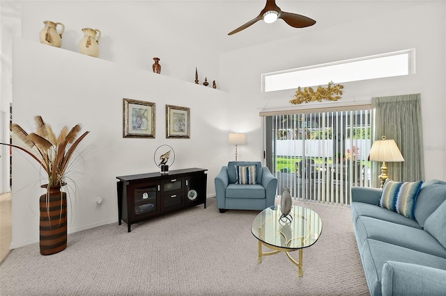 living room with a high ceiling, ceiling fan, and carpet floors