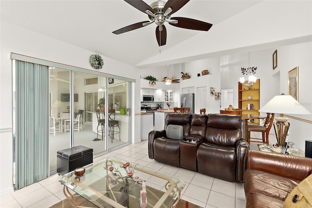 tiled living room with ceiling fan with notable chandelier and vaulted ceiling