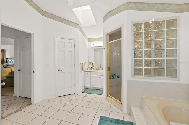 bathroom featuring tile patterned flooring, vanity, plus walk in shower, and vaulted ceiling with skylight