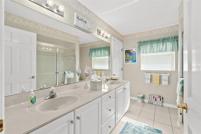 bathroom featuring vanity, a shower with door, plenty of natural light, and tile patterned floors