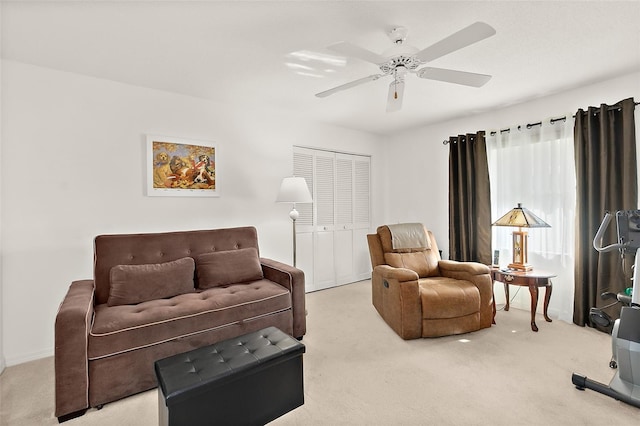 living room with ceiling fan and carpet flooring