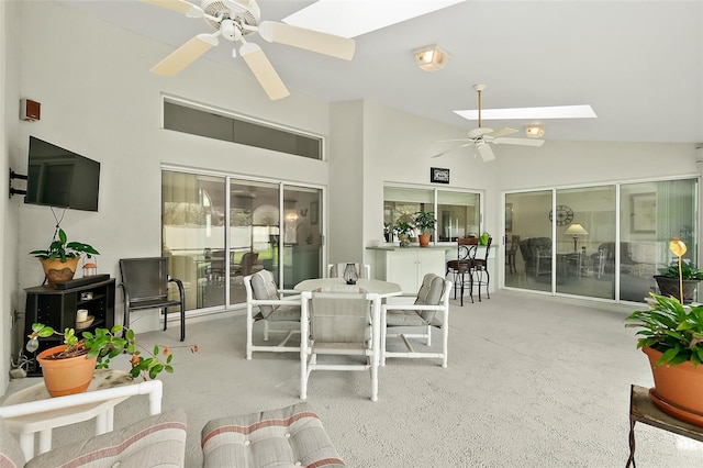 sunroom featuring ceiling fan and lofted ceiling with skylight