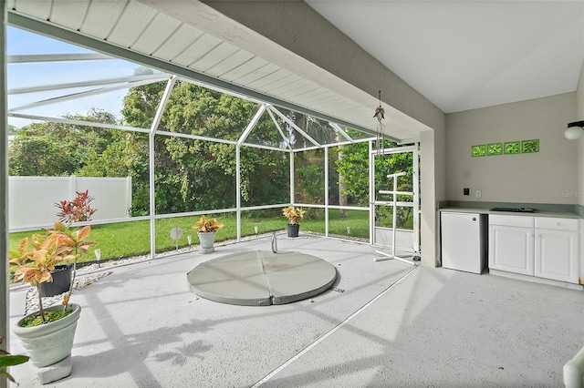 view of patio featuring a lanai