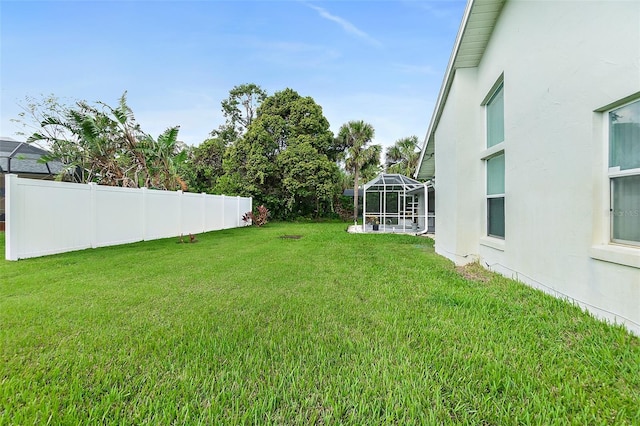 view of yard featuring glass enclosure