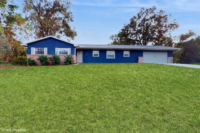 ranch-style home featuring a garage and a front lawn