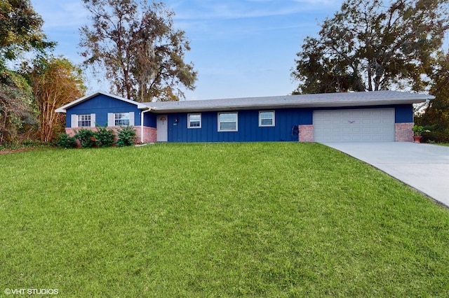 single story home featuring a garage and a front yard