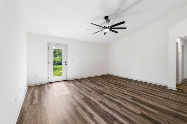 spare room featuring ceiling fan, dark wood-type flooring, and baseboards