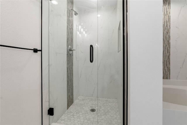 bathroom with a marble finish shower