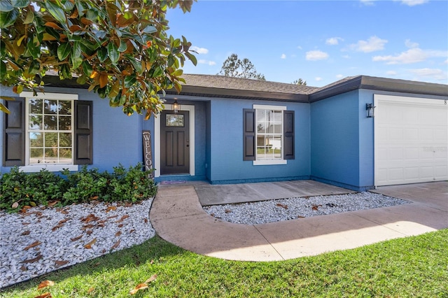 view of front of home featuring an attached garage and stucco siding