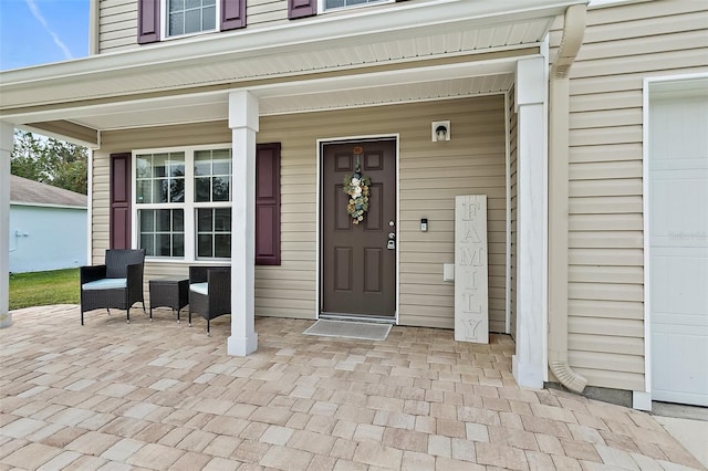 view of exterior entry featuring a porch