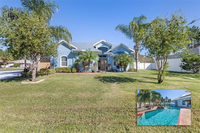 view of front facade featuring a fenced in pool and a front lawn