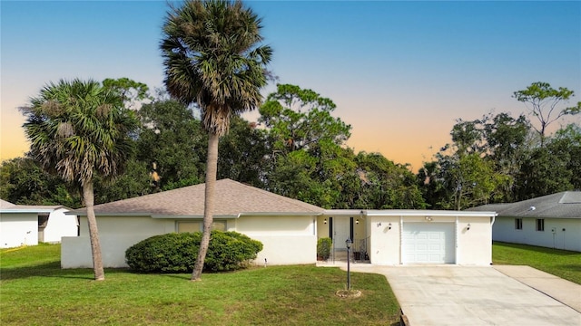 single story home with a lawn and a garage