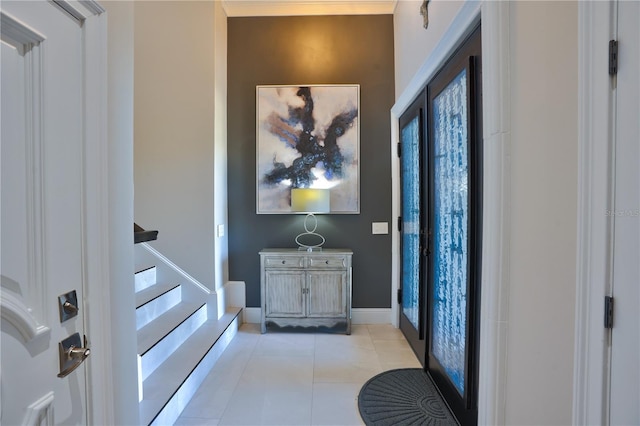 foyer featuring french doors and light tile patterned floors