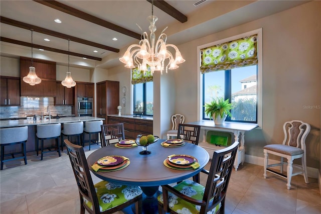 dining room with beam ceiling, sink, and a chandelier