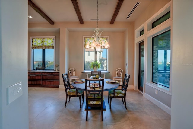 dining room with a chandelier, a healthy amount of sunlight, and beamed ceiling