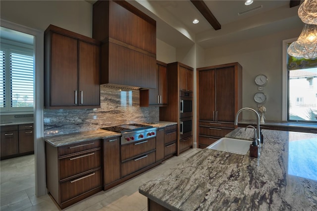 kitchen with stone countertops, beam ceiling, sink, and appliances with stainless steel finishes