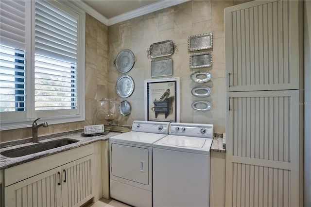 washroom with washer and clothes dryer, crown molding, and sink