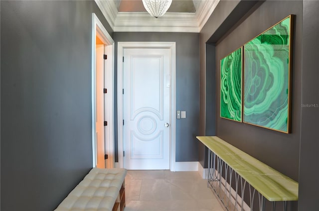 interior space featuring an inviting chandelier, tile patterned floors, and ornamental molding