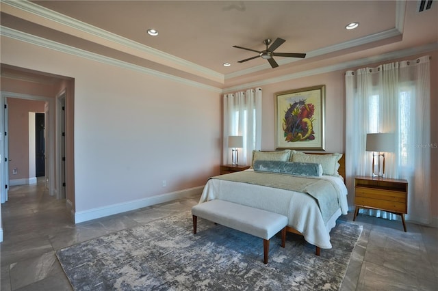 bedroom with ceiling fan, crown molding, multiple windows, and a tray ceiling