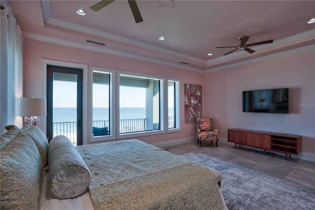 bedroom featuring access to exterior, ceiling fan, crown molding, a tray ceiling, and a water view