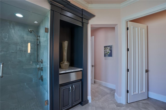 bathroom featuring vanity, ornamental molding, and a shower with door