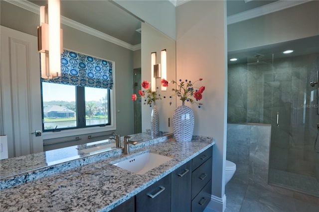 bathroom with toilet, a shower with door, vanity, and ornamental molding