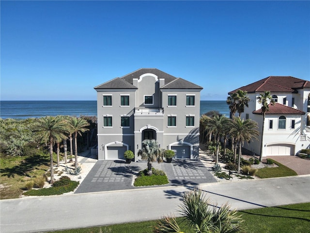 view of front of home with a water view and a garage