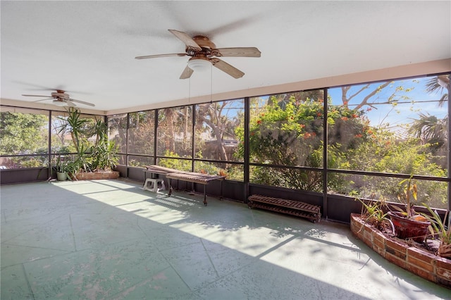 unfurnished sunroom featuring a wealth of natural light and ceiling fan