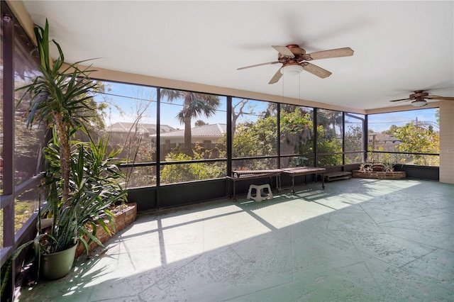 unfurnished sunroom with ceiling fan