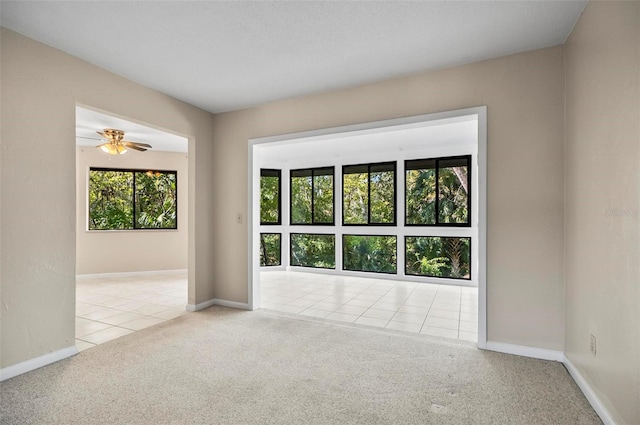 spare room featuring ceiling fan and light colored carpet