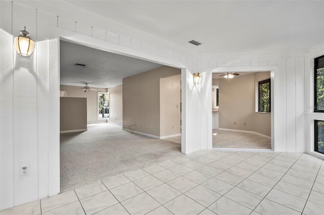 empty room featuring plenty of natural light and light colored carpet